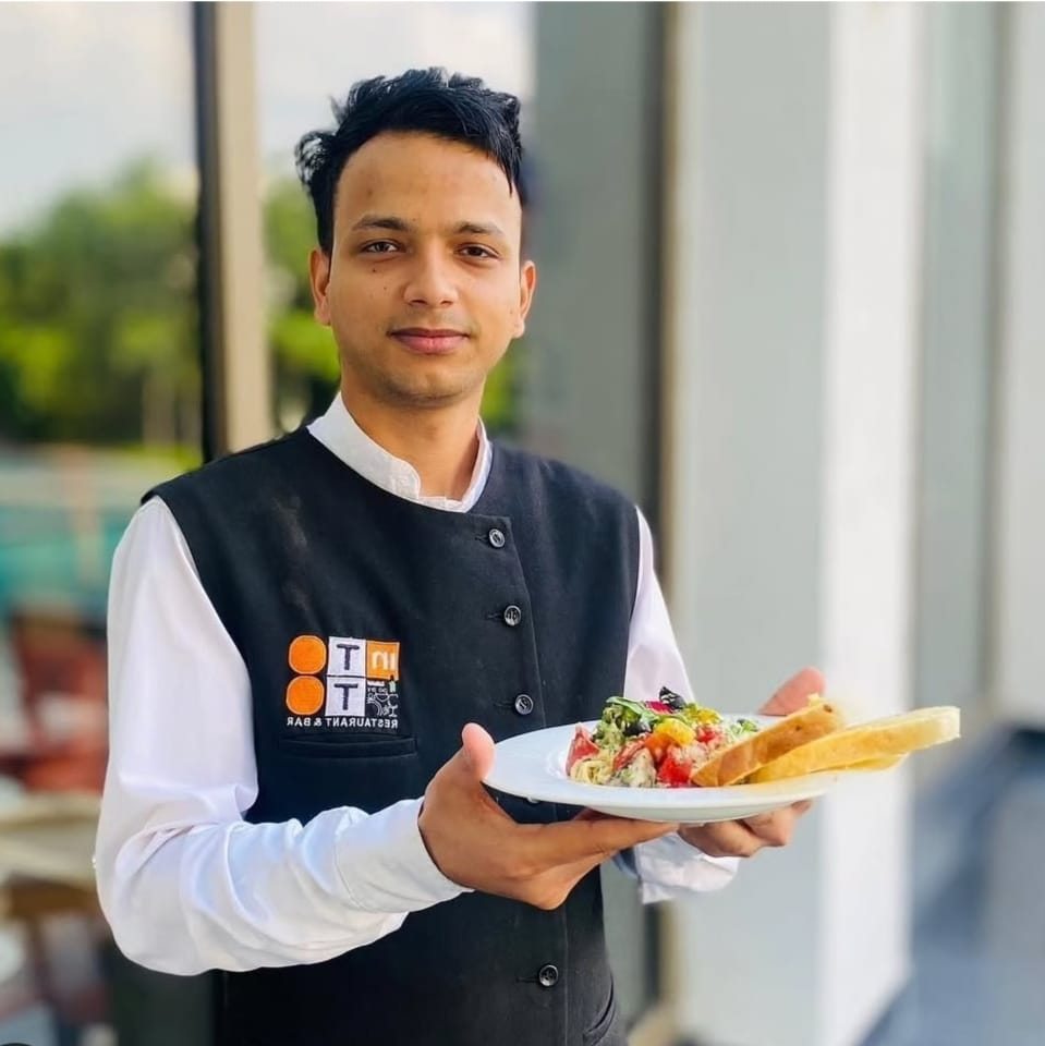 Uniformed waiter serving guests at an event